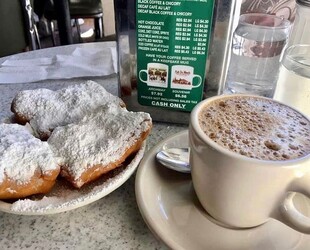 TASTING A BITE OF BEIGNETS AT CAFE DU MONDE